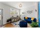 Bright living room with a blue sofa, decorative cabinet, and lots of natural light from the windows at 1903 River Birch Ln, Atlanta, GA 30316