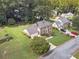 Aerial view of a two-story home with a well-kept lawn, mature trees, and a two-car garage at 4481 Lucerne Sw Pl, Lilburn, GA 30047