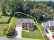 Aerial view of a brick home with a well-manicured lawn and mature trees at 4481 Lucerne Sw Pl, Lilburn, GA 30047