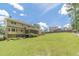 Vast backyard with manicured lawn and mature trees, highlighting the home's private outdoor space perfect for outdoor activities at 4481 Lucerne Sw Pl, Lilburn, GA 30047