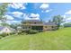 Beautiful backyard with a well-maintained lawn, a screened porch, and patio area for outdoor relaxation at 4481 Lucerne Sw Pl, Lilburn, GA 30047