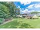 Well-maintained backyard featuring lush green grass, mature trees, and a glimpse of the house, creating a serene and spacious setting at 4481 Lucerne Sw Pl, Lilburn, GA 30047