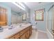 Bathroom with blue walls, a large mirror, and a walk-in shower at 4481 Lucerne Sw Pl, Lilburn, GA 30047