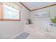 Bathroom with a large white tub with jets, white tile surround, and patterned floor at 4481 Lucerne Sw Pl, Lilburn, GA 30047