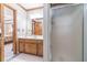 Bathroom with wood cabinets, double sinks, and tiled floor connecting to the bedroom at 4481 Lucerne Sw Pl, Lilburn, GA 30047