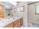 Bright bathroom with a large mirror, wooden cabinets, and plenty of counter space at 4481 Lucerne Sw Pl, Lilburn, GA 30047