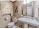 Classic bathroom with pedestal sink, decorative mirror, and neutral tones at 4481 Lucerne Sw Pl, Lilburn, GA 30047
