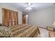Bedroom with ceiling fan, carpeted floor, closet, and neutral walls at 4481 Lucerne Sw Pl, Lilburn, GA 30047