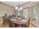Charming dining area with wood table and chairs, and ample natural light at 4481 Lucerne Sw Pl, Lilburn, GA 30047