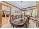 Elegant dining room with a large wooden table and ample seating for dinner parties at 4481 Lucerne Sw Pl, Lilburn, GA 30047