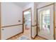 Inviting entryway features wood trim, neutral walls, and a view into the laundry room at 4481 Lucerne Sw Pl, Lilburn, GA 30047