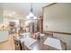 Open kitchen and dining area with stainless appliances, cabinetry, and wood floors at 4481 Lucerne Sw Pl, Lilburn, GA 30047