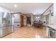 Spacious kitchen and dining area with stainless steel refrigerator and wood-look flooring at 4481 Lucerne Sw Pl, Lilburn, GA 30047