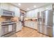 Modern kitchen with stainless steel appliances, granite counters, and ample storage in white cabinets at 4481 Lucerne Sw Pl, Lilburn, GA 30047