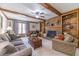 Cozy living room featuring a brick fireplace, built-in bookshelves, and comfortable seating at 4481 Lucerne Sw Pl, Lilburn, GA 30047