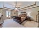 Serene main bedroom features a tray ceiling, a ceiling fan, and large windows at 4481 Lucerne Sw Pl, Lilburn, GA 30047
