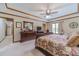Luxurious main bedroom features a large bed, wood furniture, and a decorative ceiling fan at 4481 Lucerne Sw Pl, Lilburn, GA 30047