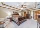 Well-lit main bedroom showcases a tray ceiling, neutral carpet, and a sitting area at 4481 Lucerne Sw Pl, Lilburn, GA 30047