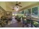 Charming screened-in porch featuring comfortable seating, ceiling fans, and a dining area, providing a relaxing outdoor living space at 4481 Lucerne Sw Pl, Lilburn, GA 30047