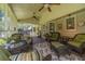 Inviting screened-in porch featuring comfortable seating, ceiling fans, outdoor decor perfect for relaxing and entertaining at 4481 Lucerne Sw Pl, Lilburn, GA 30047