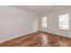 Spacious bedroom featuring two windows offering natural light, complimented by wood-look flooring at 3987 Bayside Cir, Atlanta, GA 30340