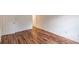 Bedroom featuring wood-look flooring, a white door, and base trim around the perimeter at 3987 Bayside Cir, Atlanta, GA 30340
