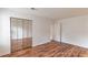 Bedroom featuring wood-look flooring, a closet with mirrored doors and a white door at 3987 Bayside Cir, Atlanta, GA 30340