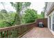 Outdoor deck with railing and grill overlooking lush greenery, perfect for outdoor dining at 3987 Bayside Cir, Atlanta, GA 30340