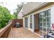 Outdoor wooden deck with grill and sliding glass doors, perfect for entertaining at 3987 Bayside Cir, Atlanta, GA 30340