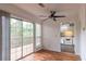 Dining area featuring a ceiling fan, sliding glass doors to the deck, and a view of the kitchen at 3987 Bayside Cir, Atlanta, GA 30340