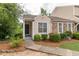 Charming townhouse exterior with stone accents, inviting front porch, and landscaped walkway at 3987 Bayside Cir, Atlanta, GA 30340