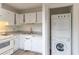 Kitchen with updated appliances including stacked in-unit washer and dryer at 3987 Bayside Cir, Atlanta, GA 30340