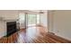 Bright living room featuring hardwood floors, a fireplace, and sliding glass doors to the deck at 3987 Bayside Cir, Atlanta, GA 30340