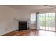 Bright living room with a fireplace, hardwood floors, and access to an outdoor deck at 3987 Bayside Cir, Atlanta, GA 30340