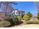 Stately back exterior view showcasing decks, a screened porch, and tiered landscaping at 4620 Chattahoochee Se Xing, Marietta, GA 30067