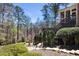 Enjoy nature in this backyard with landscaped features and a staircase to an elevated deck at 4620 Chattahoochee Se Xing, Marietta, GA 30067