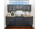 Stylish bar area featuring custom cabinetry, granite countertops, and mirrored backsplash at 4620 Chattahoochee Se Xing, Marietta, GA 30067