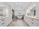 Luxurious bathroom with double vanities, standalone tub, and tiled floors at 4620 Chattahoochee Se Xing, Marietta, GA 30067