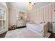 Charming bedroom with striped wallpaper, hardwood floor, and a window at 4620 Chattahoochee Se Xing, Marietta, GA 30067