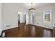Dining room with white walls, wood floors, plantation shutters, and modern chandelier at 4620 Chattahoochee Se Xing, Marietta, GA 30067