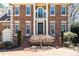 Elegant brick home with decorative columns, manicured landscaping, and a brick driveway at 4620 Chattahoochee Se Xing, Marietta, GA 30067