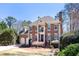 Attractive brick home boasts a manicured lawn and attached two-car garage at 4620 Chattahoochee Se Xing, Marietta, GA 30067