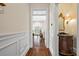 Hallway view featuring hardwood floors and decorative moldings plus a view of the living area and powder room at 4620 Chattahoochee Se Xing, Marietta, GA 30067