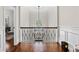 Hallway with hardwood floors, decorative railing, and a view of an adjacent room at 4620 Chattahoochee Se Xing, Marietta, GA 30067