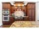 Gourmet kitchen featuring stainless appliances, custom cabinetry and granite countertops at 4620 Chattahoochee Se Xing, Marietta, GA 30067