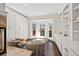 Bright living room featuring custom built-ins, hardwood floors, and doors to private balcony at 4620 Chattahoochee Se Xing, Marietta, GA 30067