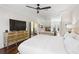 Primary bedroom featuring hardwood floors, fireplace, ceiling fan, and sitting area at 4620 Chattahoochee Se Xing, Marietta, GA 30067