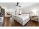 Large primary bedroom featuring hardwood floors, a ceiling fan, fireplace, and lots of natural light at 4620 Chattahoochee Se Xing, Marietta, GA 30067