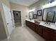 Bathroom with double sinks, vanity, quartz countertops, and a walk-in closet at 1601 Bonica Xing # 1601, Cumming, GA 30040