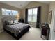 Cozy bedroom with natural light, plush carpet, and soft, neutral color scheme at 1601 Bonica Xing # 1601, Cumming, GA 30040